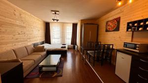 a living room with a couch and a dining room at Bansko Royal Towers - Studio 1237 in Bansko