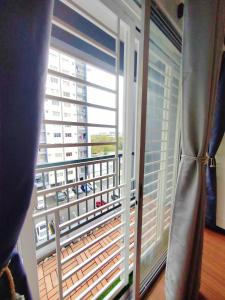 a large window with a view of a balcony at QM Homestay in Semenyih