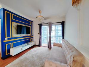 a living room with a couch and a tv at QM Homestay Ecohill in Semenyih