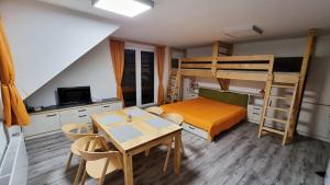 多尼蒙拉沃的住宿－Apartmány Marek a Michal，一间卧室配有餐桌和一张双层床。