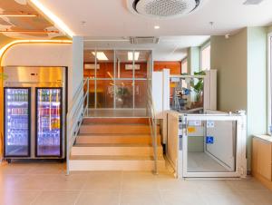 a lobby with stairs and elevators in a building at B&B HOTEL Santos Dumont in Rio de Janeiro