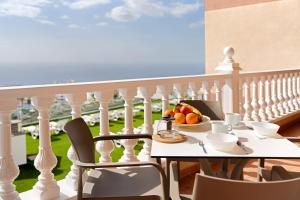 a table with a bowl of fruit on a balcony at La Tablada Atlantic Sea View in Adeje