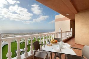 a balcony with a table and chairs with a view of the ocean at La Tablada Atlantic Sea View in Adeje