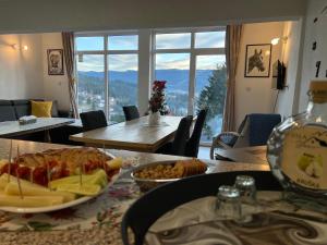 a living room with a table with a plate of food at Vila Starcevic in Pale +42 photos