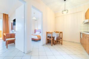 a kitchen and living room with a bed and a table at Lido Sofia Apartments in Agios Gordios