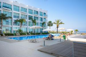 a hotel with a swimming pool and a resort at Studio in Protaras in Protaras