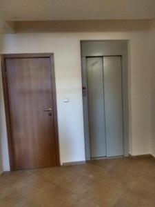 an empty room with two doors in a building at Kolimechkov Apartments Borovets in Borovets