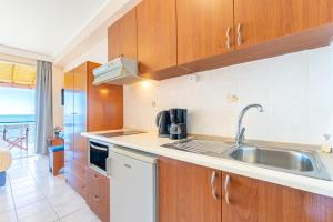 a kitchen with a sink and a counter top at Lido Sofia Apartments in Agios Gordios