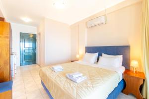 a bedroom with a bed with two towels on it at Lido Sofia Apartments in Agios Gordios