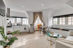 a living room with a couch and a table at Lovely Kensington Apartments in London