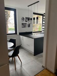 a kitchen with a table and a sink and a table and chairs at Köln Zentrum - Top Wohnung für 8 Personen in Cologne