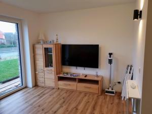 a living room with a flat screen tv on a wall at Neubauferienwohnung Ankerplatz in Stein