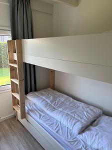 a bunk bed in a room next to a window at Stormvloed in Renesse