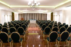 a room with rows of chairs and a table at Pergola Hotel & Spa in Mellieħa