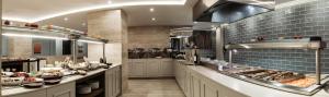 a large kitchen with a buffet of food at Pergola Hotel & Spa in Mellieħa