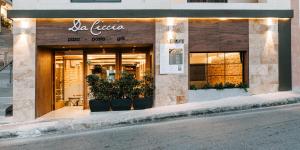 a store front of a building with plants in front at Pergola Hotel & Spa in Mellieħa
