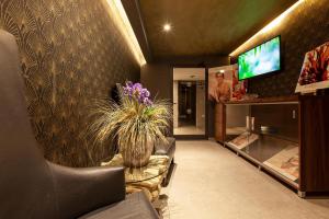 a lobby with a vase of flowers on a wall at Pergola Hotel & Spa in Mellieħa