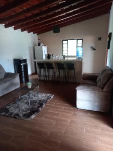 a living room with a couch and a table at Chácara dos Ypes in Bueno Brandão