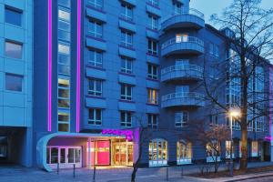 a blue building with pink lighting in front of it at MOXY Berlin Humboldthain Park in Berlin