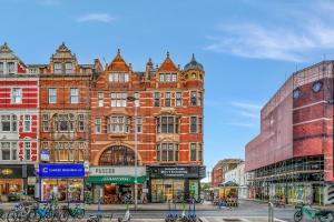 a large brick building in the middle of a street at Lovely Kensington Apartments in London