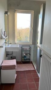 a small bathroom with a sink and a window at Welkom in Vloesberg n°54 in Flobecq