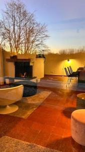 a living room with a fireplace and a table and chairs at Welkom in Vloesberg n°54 in Flobecq
