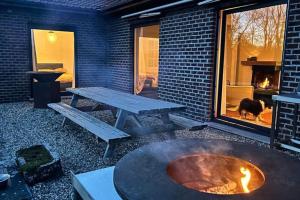 a patio with a picnic table and a fire pit at Welkom in Vloesberg n°54 in Flobecq