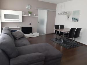 a living room with a couch and a table at Ferienwohnung Leithaberg in Eisenstadt