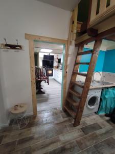 a room with a staircase and a washing machine at Residence l'Oncet - Appartement 8 personnes in Barèges