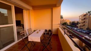 a balcony with a table and chairs on a balcony at Sea and views close to Marbella in Cabopino