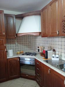 a kitchen with wooden cabinets and a stove top oven at Casa di Peppe o'Biond in Procida