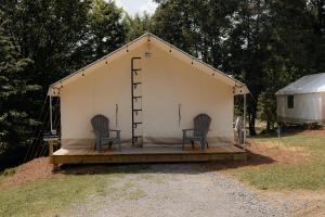 two chairs sitting in a tent with a ladder at Glamping Tents 2 Queens at Lake Guntersville State Park in Guntersville +19 photos