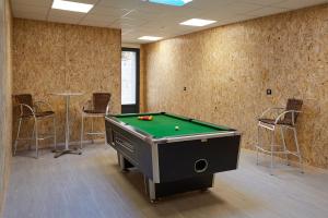 a billiard room with a pool table and chairs at Paradis Champenois in Damery