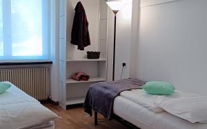 ein kleines Schlafzimmer mit zwei Betten und einem Fenster in der Unterkunft Verde Pieve in Pieve Di Ledro