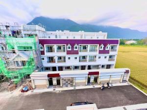 an aerial view of a large building with a parking lot at Yamada Heart B&B in Hualien City