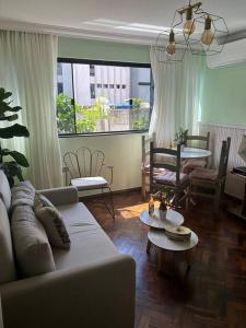 a living room with a couch and a table at Casa de Ana - no coração de Bsb! in Brasilia