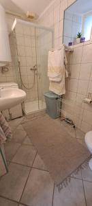 a bathroom with a shower and a sink and a toilet at Tünde lak in Siófok +6 photos