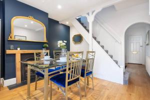 a dining room with a table and a staircase at Newly Renovated 2 Bed Cottage - call for discount in Windsor