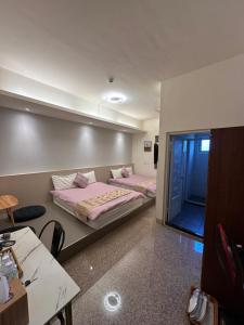a room with two beds and a tv in it at Royal Yado in Zhixue
