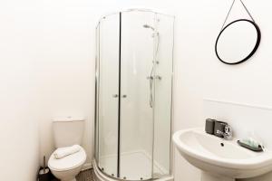 a bathroom with a shower and a toilet and a sink at Suite 3 - Stunning Room in Oldham Sociable House in Oldham