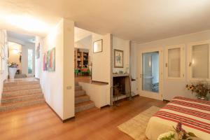 a room with a bed and a staircase in it at Villa Margherita Sardegna 250m from the beach in Fort Village