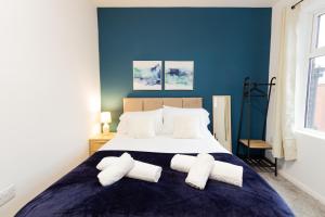 a bedroom with a large bed with two pillows at Suite 3 - Stunning Room in Oldham Sociable House in Oldham