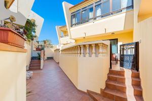 a villa with a staircase leading up to a house at MEDANO4YOU Marina Home By The Sea in El Médano