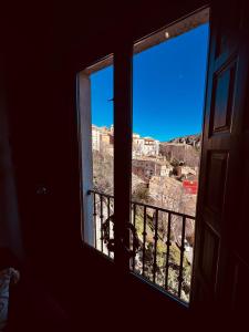 a room with two windows with a view of a city at Rascacielos San Martín in Cuenca