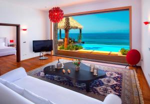 a living room with a view of the ocean at Porto Zante Villas And Spa in Tragaki