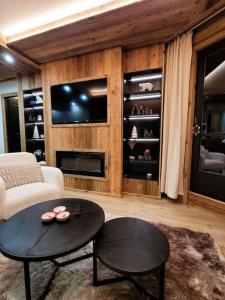 a living room with a couch and a table at LES ARCS Appartement Prestige Ski In Ski Out in Bourg-Saint-Maurice