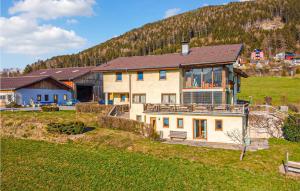 a large house in a field with a mountain at Beautiful Apartment In Patsch With Wifi And 2 Bedrooms in Innsbruck