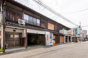 an empty street in an asian city with buildings at Private reservation near KIX "Wakeikan" in Hannan