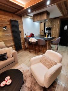 a living room with a couch and a table at LES ARCS Appartement Prestige Ski In Ski Out in Bourg-Saint-Maurice