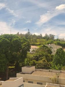 a view of a city with trees and buildings at Hotel Mãe Morena in Aparecida